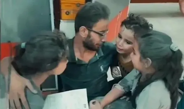 Katliamın ortasında baba tesellisi! Bombardıman korkusuyla ağlayan çocuklarına kol kanat gerdi