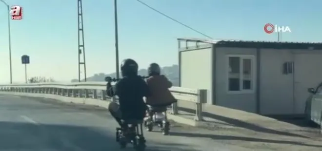 Trafikte ilginç anlar: Taburenin üzerine oturarak elektrikli scooter kullandılar