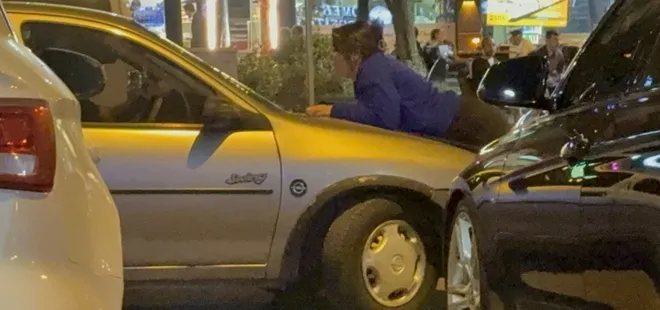 Kocasıyla tartışan kadın aracın kaputuna çıktı