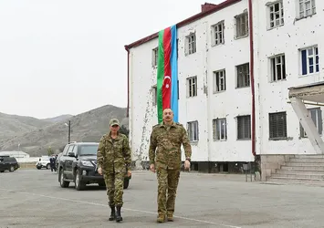 İlham Aliyev işgalden kurtarılan bölgede Azerbaycan bayrağını öperek göndere çekti